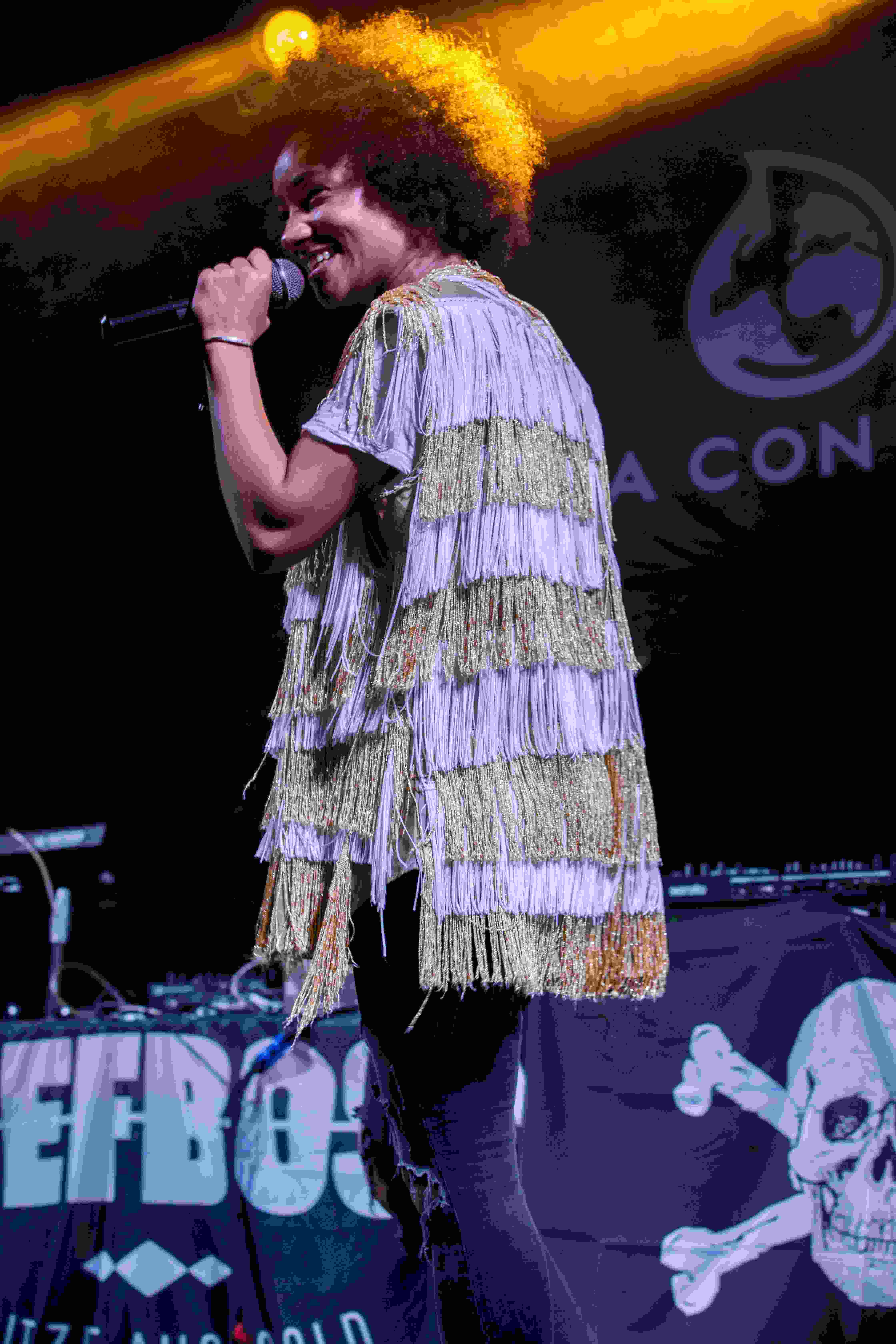 picture, person with a fringed jacket singing