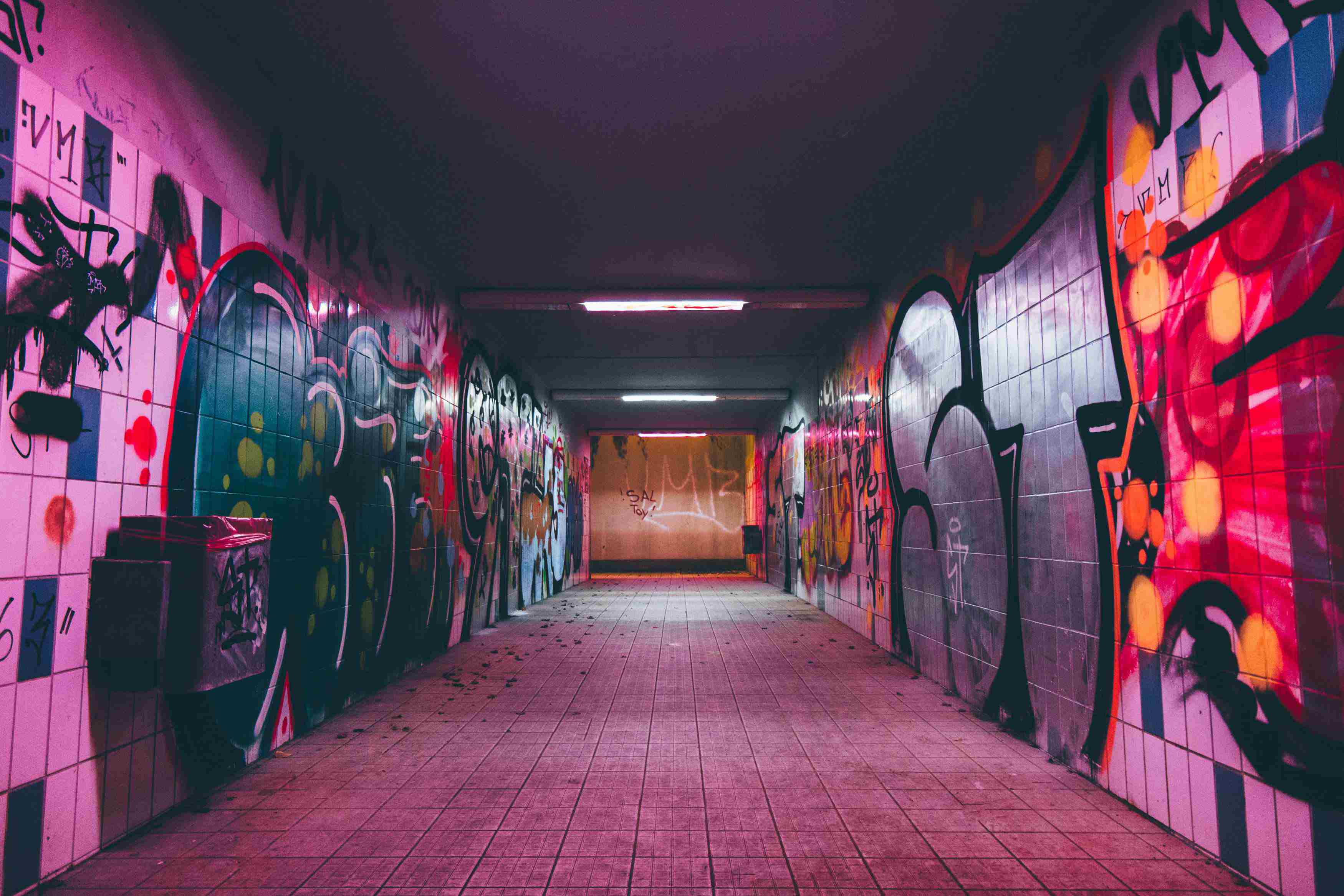 picture, tunnel with graffiti-covered walls in purple light